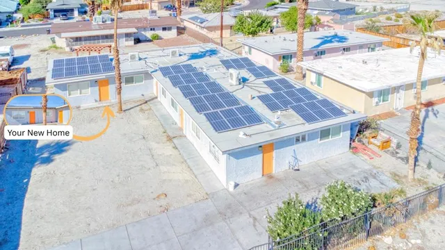 an aerial view of residential houses with outdoor space