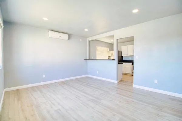 a view of kitchen with wooden floor and electronic appliances