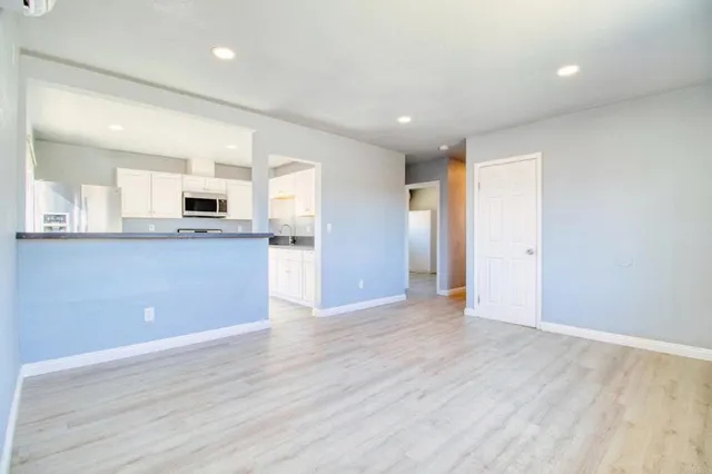 a kitchen with granite countertop a refrigerator stove and microwave