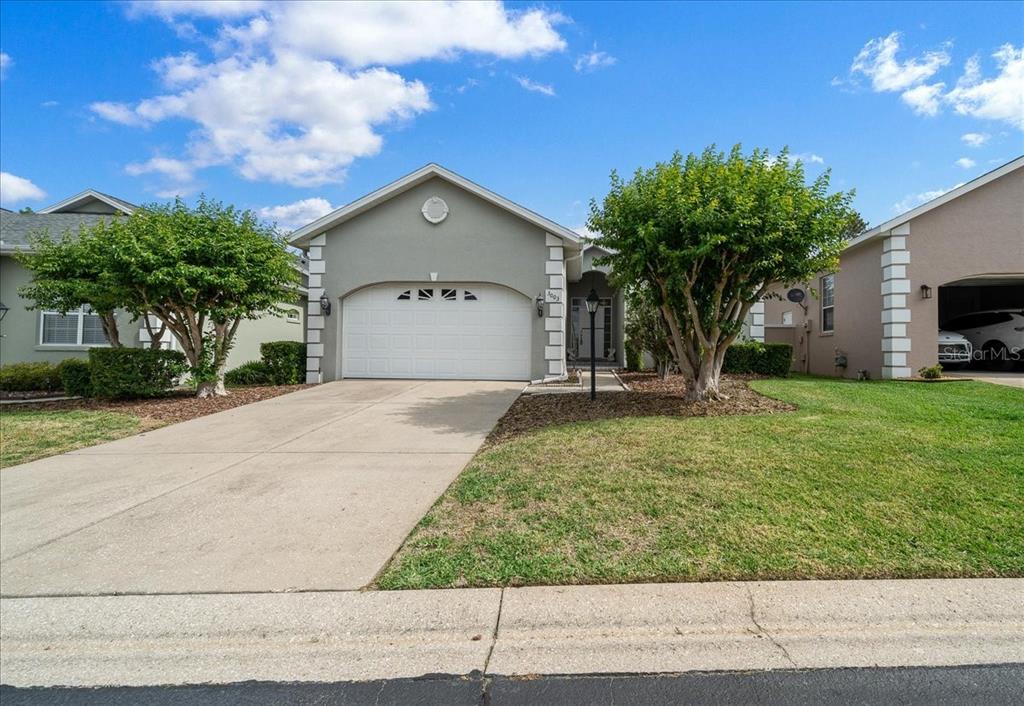 3003 Southwest 41st Place Ocala, FL 34474 - Photo 2 of 65 a house view with a garden space