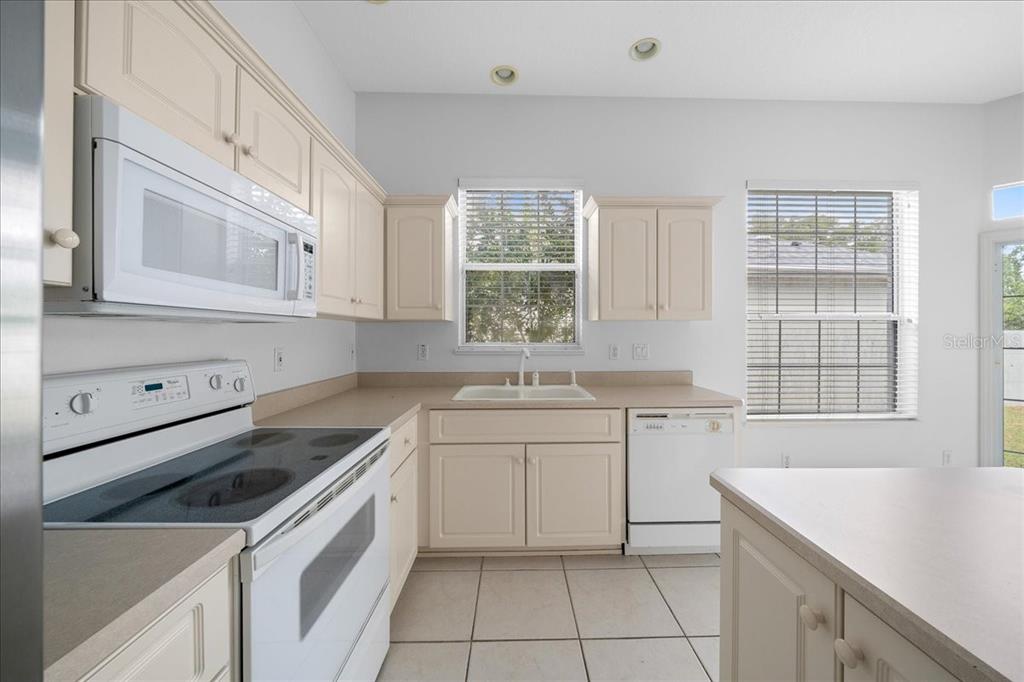 3003 Southwest 41st Place Ocala, FL 34474 - Photo 27 of 65 a kitchen that has a sink and a stove in it