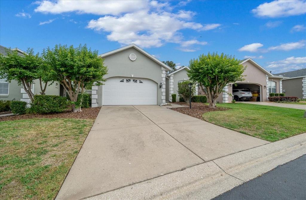 3003 Southwest 41st Place Ocala, FL 34474 - Photo 3 of 65 a house with garden in front of it
