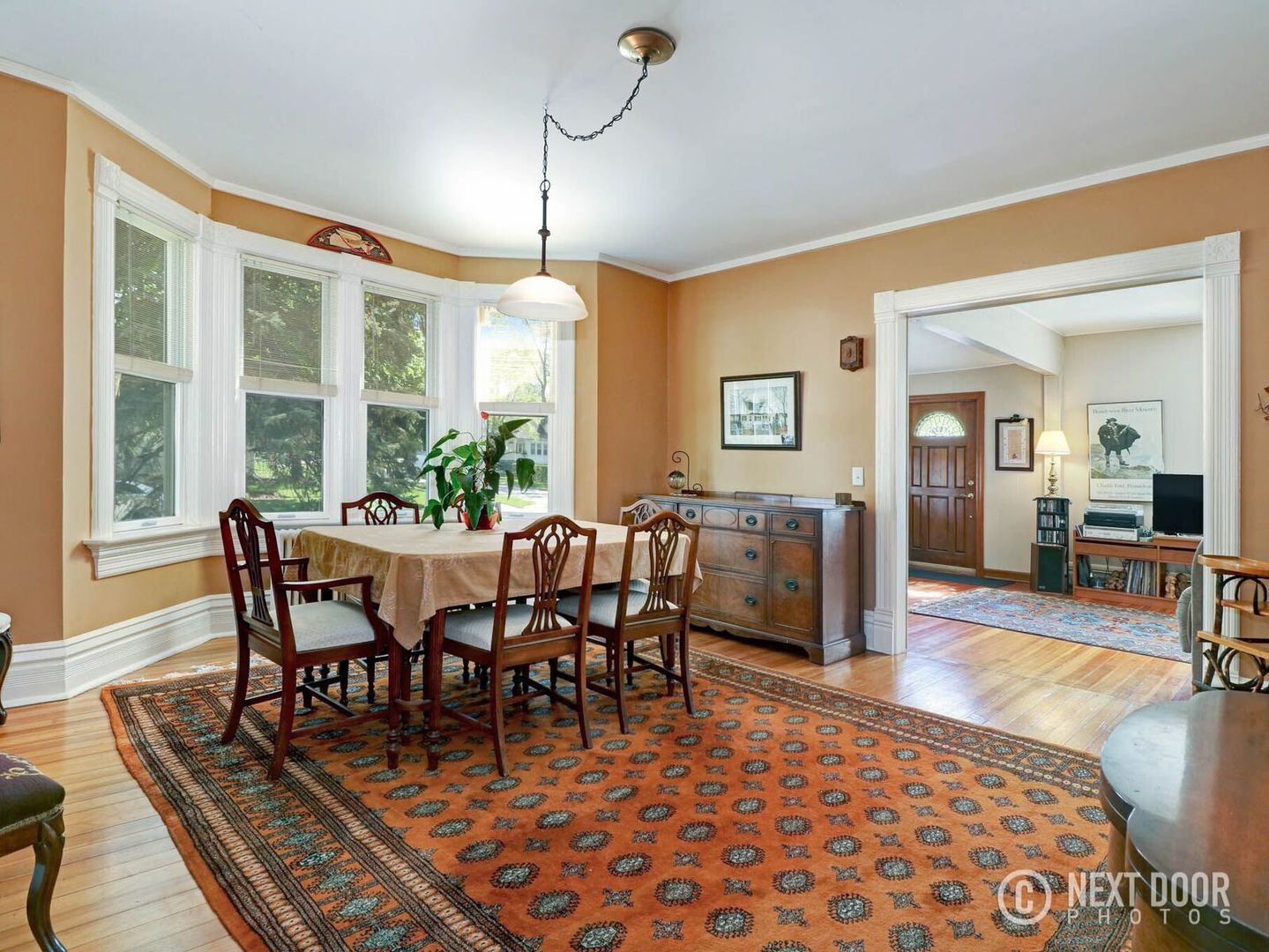 125 South Maple Street Itasca, IL 60143 - Photo 11 of 24 a dining room with furniture a rug a potted plant and a chandelier