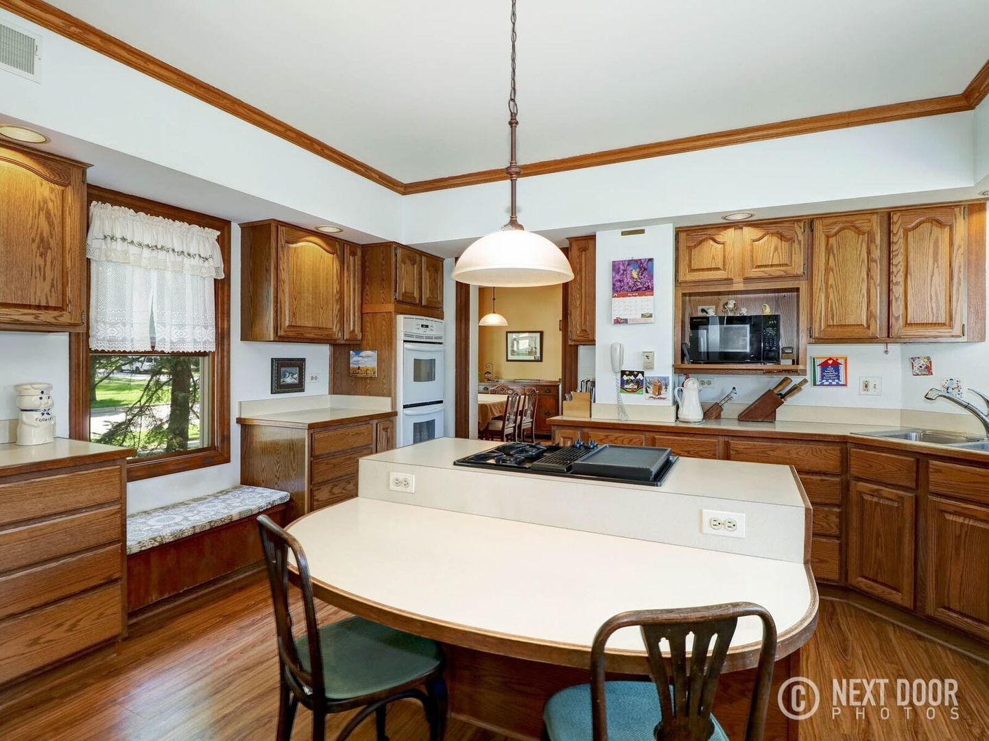 125 South Maple Street Itasca, IL 60143 - Photo 10 of 24 a kitchen with a dining table chairs refrigerator and cabinets
