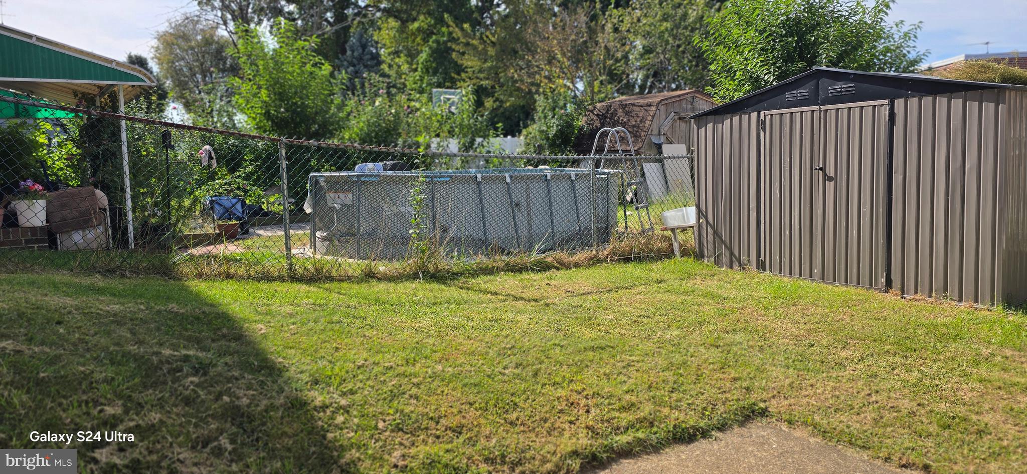 2806 Walnut Hill Street Philadelphia, PA 19152 - Photo 31 of 34 a view of backyard with wooden fence and large trees