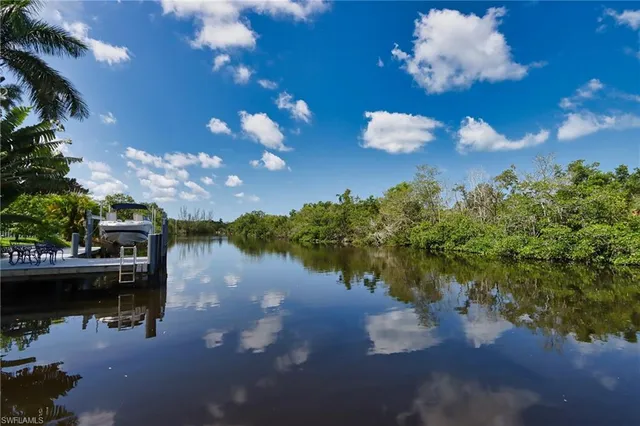 a view of a lake in between two chairs