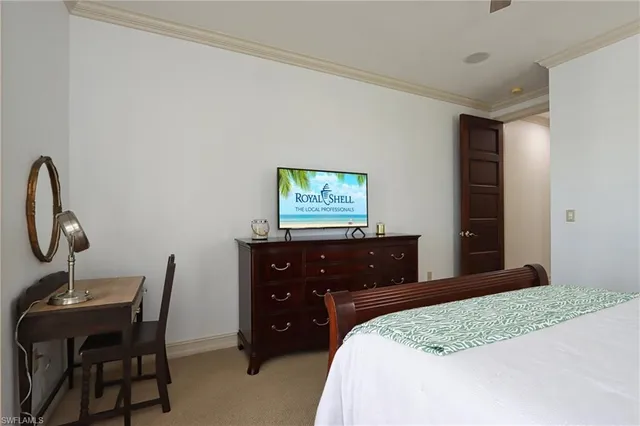 a bedroom with a bed and a desk