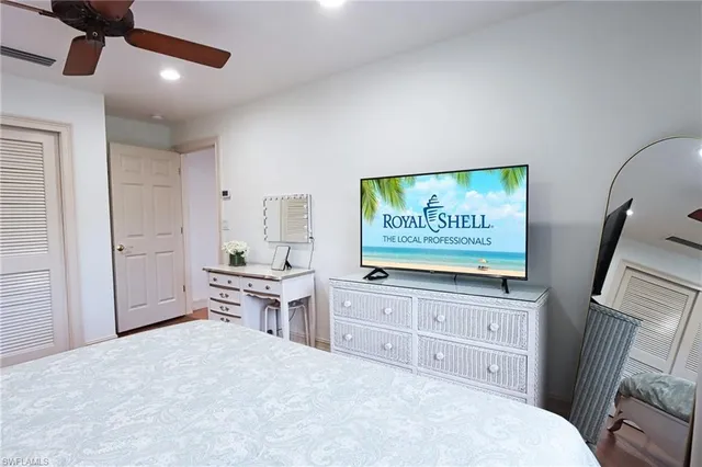 a large bedroom with a bed and a television