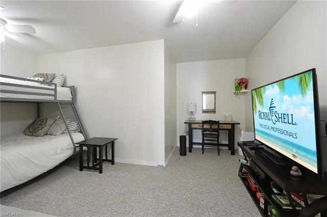 a bedroom with furniture and a flat screen tv