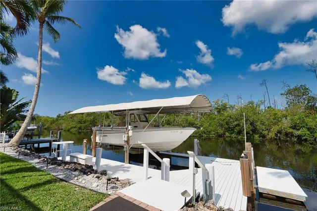 a view of a patio with table and chairs and potted plants