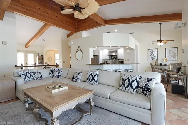 a living room with furniture a rug and a chandelier