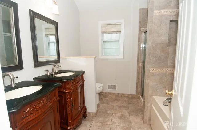a white bath tub sitting next to a shower