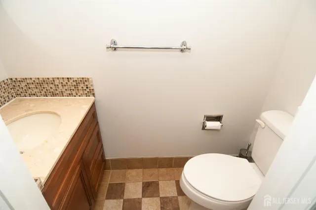 a kitchen with granite countertop a refrigerator and a stove top oven