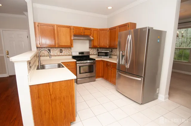 a kitchen with a sink stove and cabinets