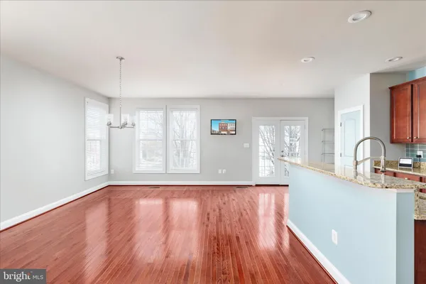 a view of a kitchen with wooden floor and a window