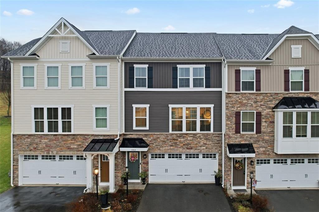 a front view of a residential apartment building with a yard