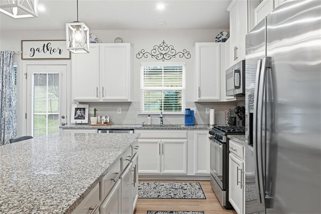 102 Rivulet Place Zelienople, PA 16063 - Photo 11 of 35 a kitchen with stainless steel appliances granite countertop a sink stove and refrigerator