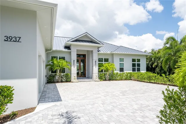 a front view of a house with a garden and plants