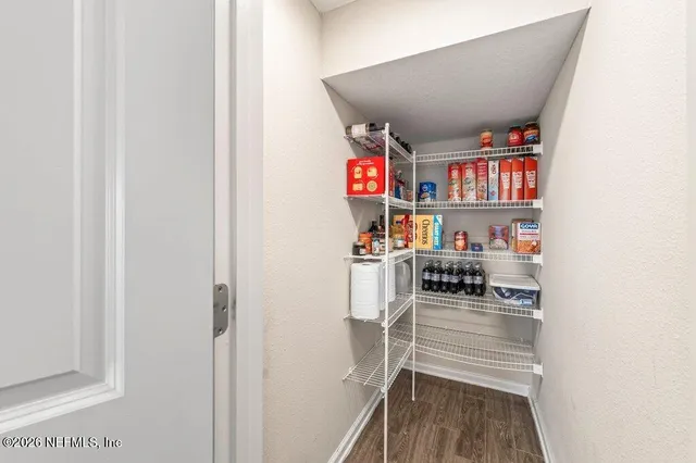 an empty room with a ceiling fan and window