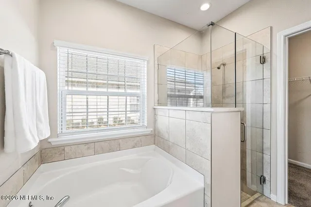 a bathroom with a bathtub and window