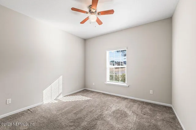 a bedroom with a bed a chandelier and dresser