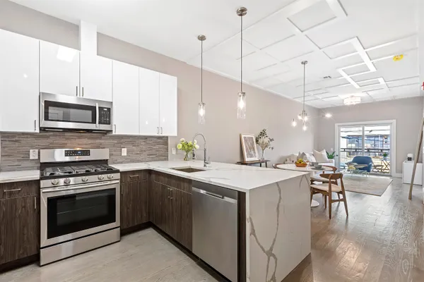 a kitchen with a stove a sink and a refrigerator