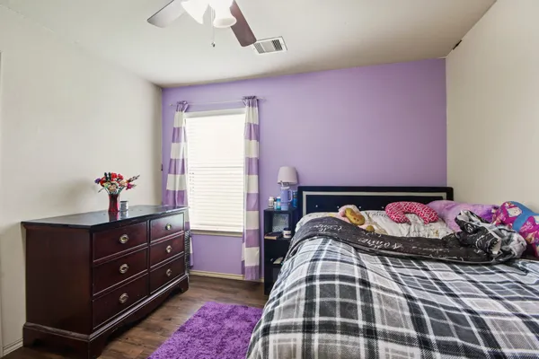a bedroom with a bed and a dresser