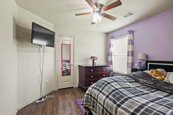 a bedroom with a bed and a dresser in it