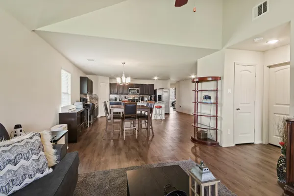 a living room with furniture and wooden floor
