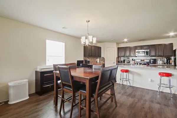 a view of a dining room with furniture window and wooden floor