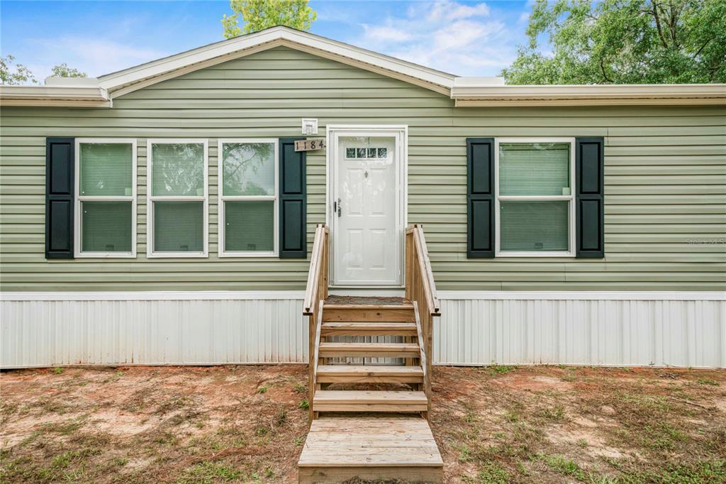 a view of a house with a window and stairs