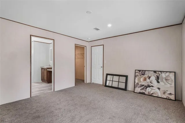 a view of an empty room with painting on the wall