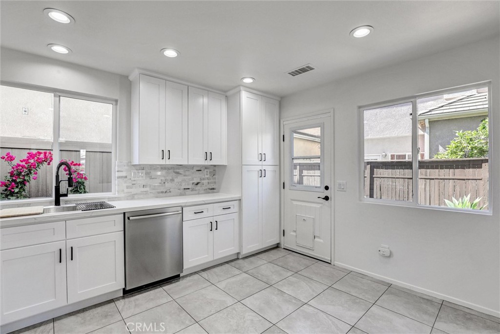 12 Poppyfield Lane Rancho Santa Margarita, CA 92688 - Photo 3 of 35 a kitchen with white cabinets and sink