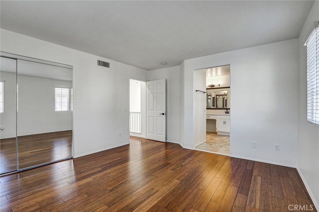 12 Poppyfield Lane Rancho Santa Margarita, CA 92688 - Photo 10 of 35 a view of empty room with wooden floor and window