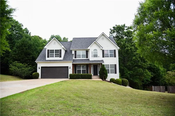 a front view of a house with a yard and garage