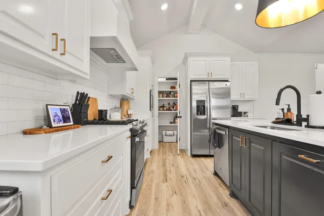 a kitchen with refrigerator and cabinets