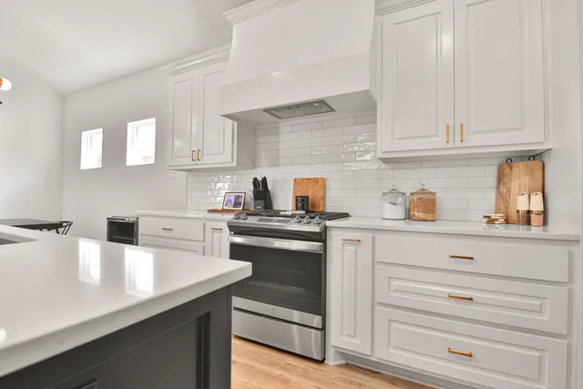 a kitchen with cabinets appliances a sink and a counter space
