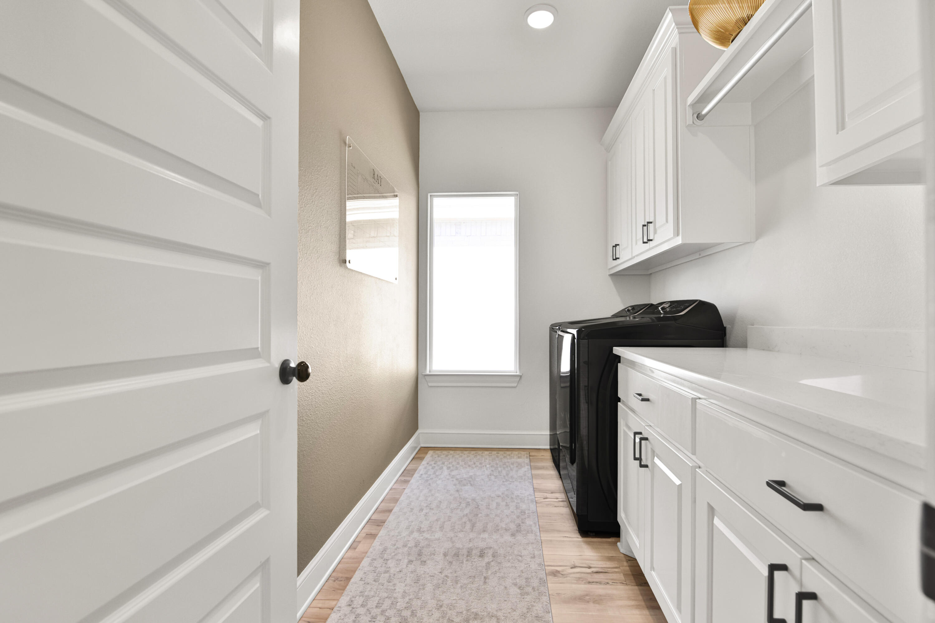 3706 144th Street Lubbock, TX 79423 - Photo 22 of 36 a kitchen with white cabinets and a refrigerator