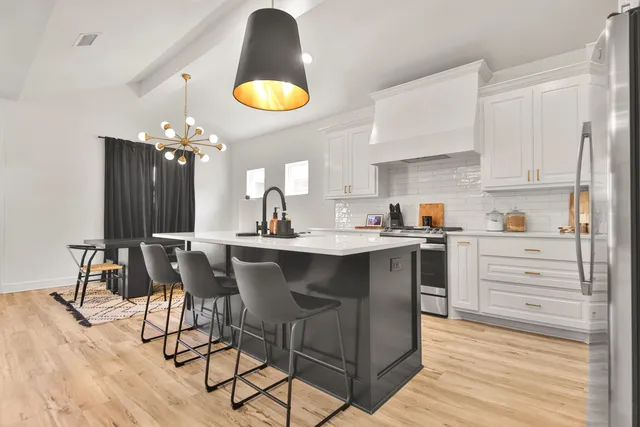 a kitchen with a sink cabinets and window