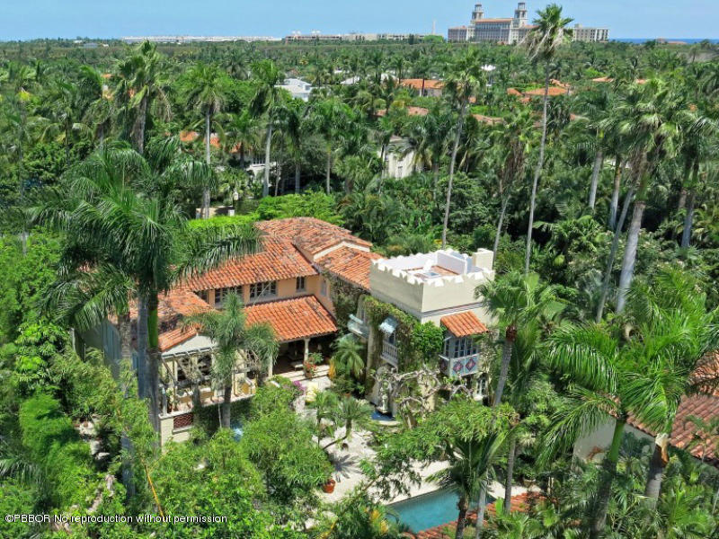 an aerial view of a house with yard and outdoor seating