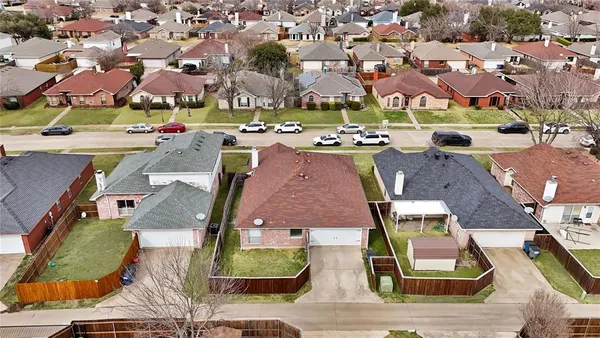 an aerial view of residential houses with outdoor space