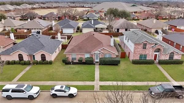 an aerial view of a residential houses with outdoor space