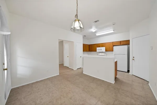 a view of a kitchen with a sink and dishwasher oven with wooden floor
