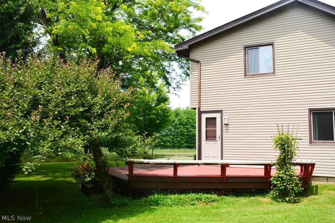5585 Gibbs Road Andover, OH 44003 - Photo 6 of 33 Rear view of house featuring a deck and a yard