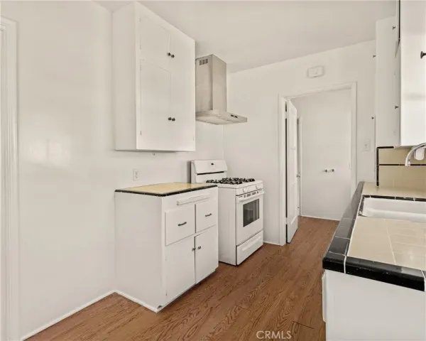 a kitchen with white cabinets and white appliances