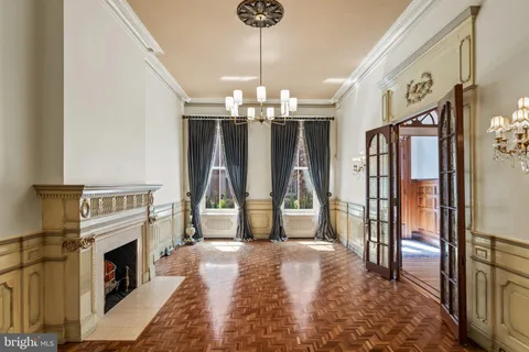 a view of empty room with wooden floor and fireplace