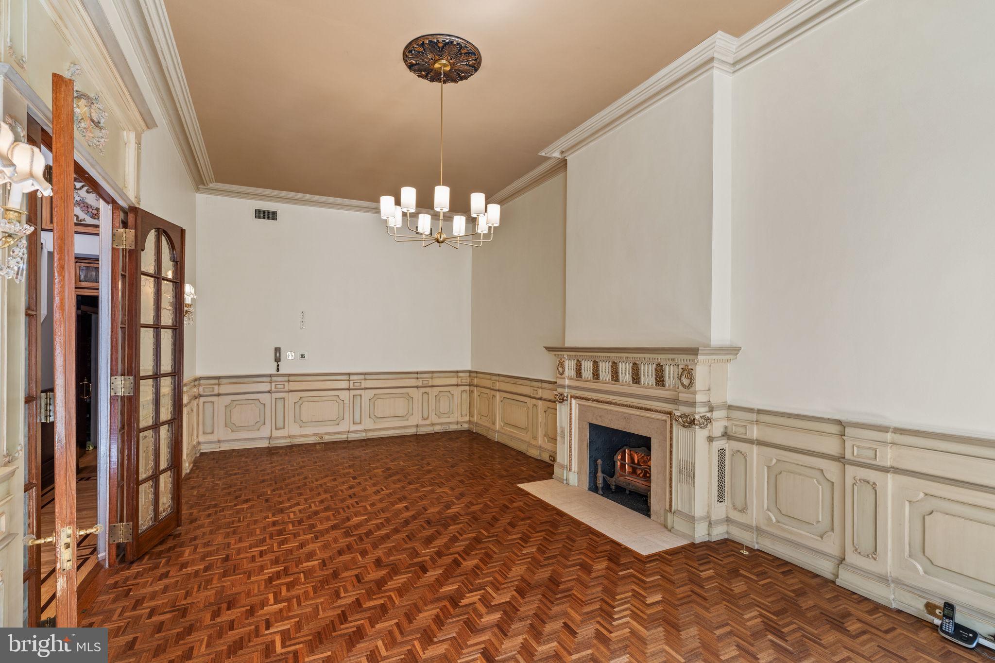 2013 Delancey Place Philadelphia, PA 19103 - Photo 13 of 79 a view of a livingroom with a fireplace a chandelier and wooden floor
