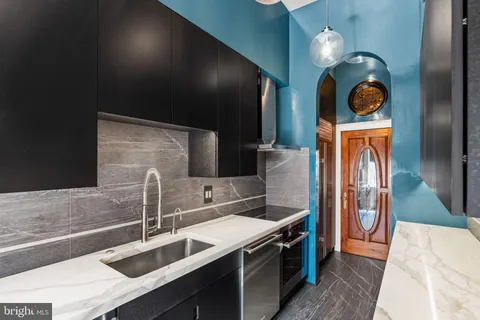 a view of an empty room with a fireplace and wooden floor