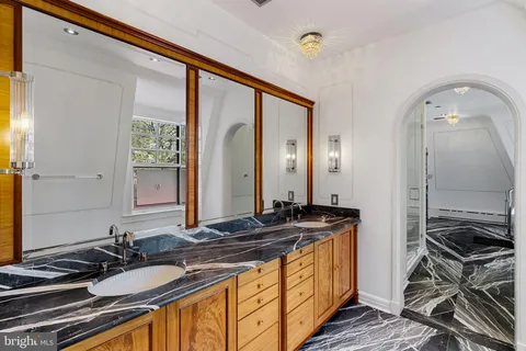 a view of walk in closet with window and wooden floor