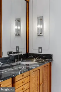 a view of a hallway with wooden floor and closet